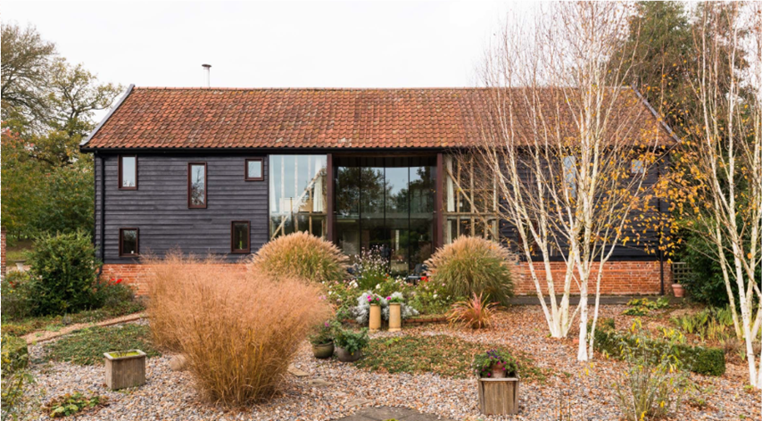 Holiday home with black timber cladding red tiled roof- Property Management- ajc consultancy swansea south wales